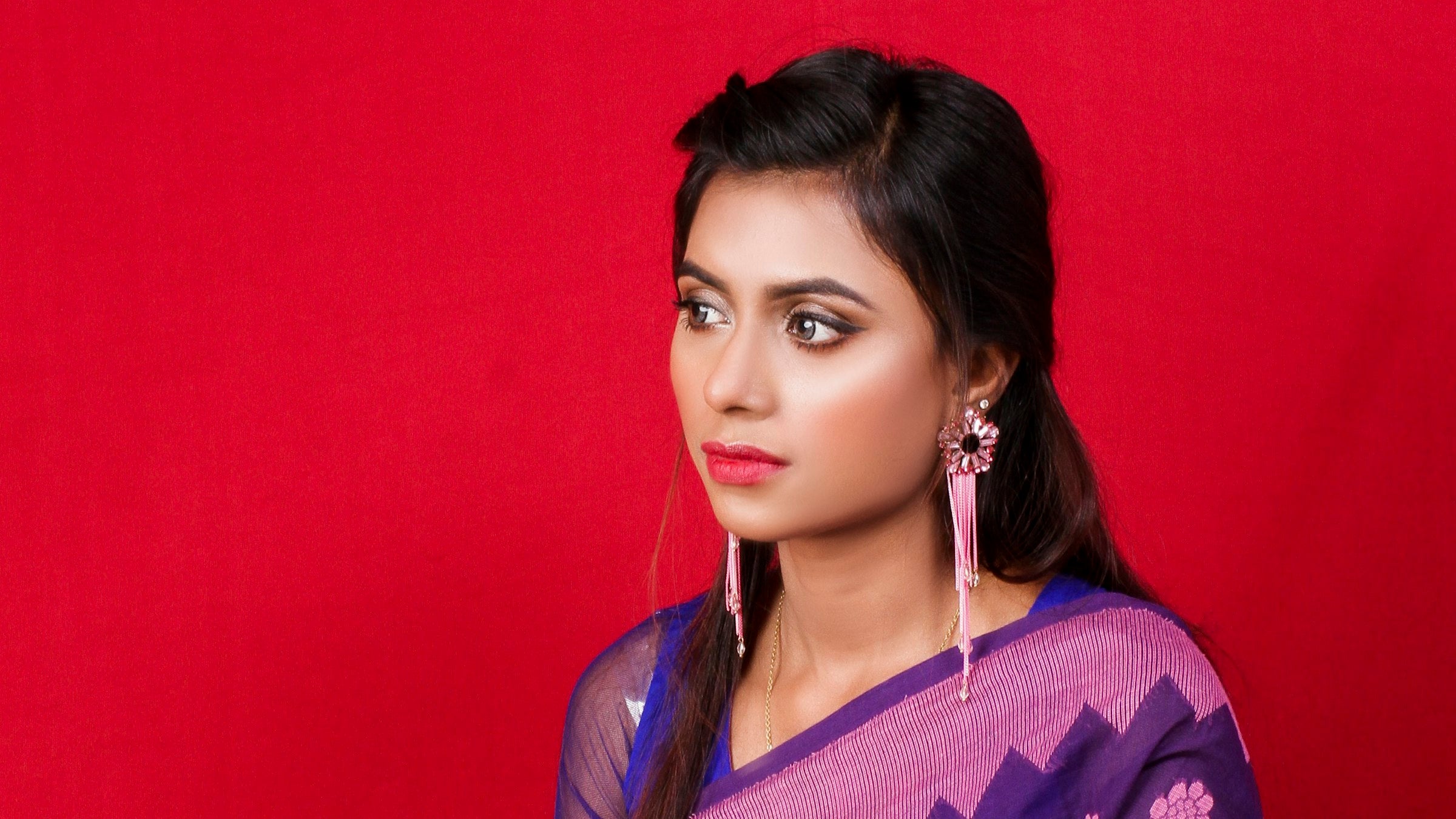 Woman draped in a purple silk saree - Label by Natheera